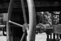 aap-centrifugal-pump-cavitation-causes-and-npsh-calculation-guide-1791554418 Close-up of a rusty metal wheel on industrial machinery in a black and white setting.