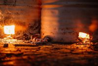 aap-industrial-furnace-refractory-lining-selection-and-failure-prevention-1791900021 Rustic barrels with glowing embers emit warm light, showcasing raw energy and industrial ambiance.