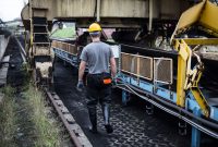 aap-predictive-maintenance-technologies-for-industrial-equipment-1790866898 A worker in safety gear examines industrial machinery in an outdoor setting, showcasing industry work.