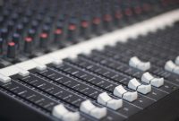 aap-variable-frequency-drive-selection-for-industrial-motor-applications-1791083500 Detailed view of a sound mixer panel with sliders and knobs for audio control.